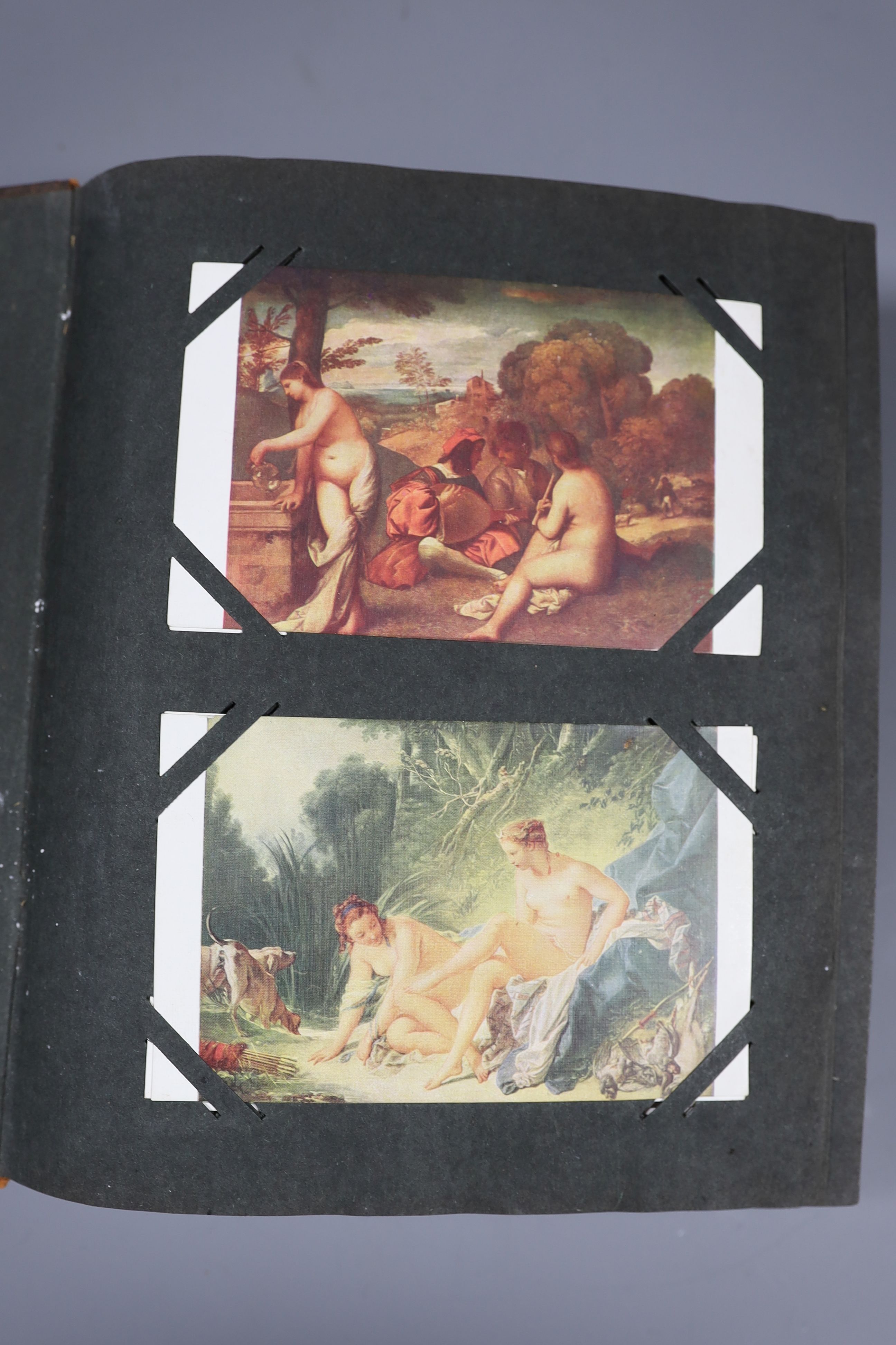 An Edwardian green postcard album, mounted with 68 risqué cards and a brown album mounted with Edwardian, George V and later, mainly topographical cards (2)